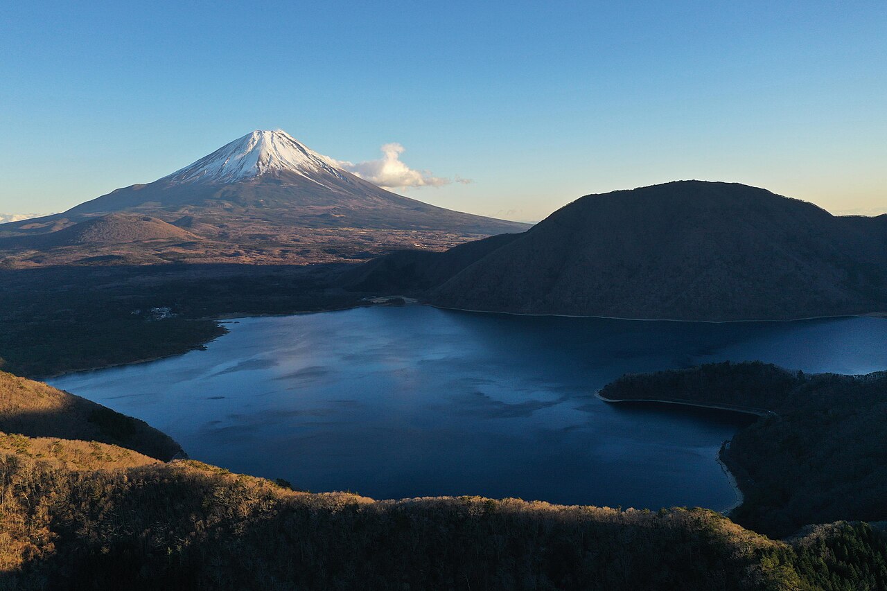 Snow-capped Mount Fuji rising above Lake Motosu in clear evening light photo_0 Snow-capped Mount Fuji rising above Lake Motosu in clear evening light photo_0